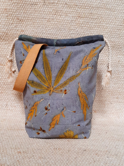 ecoprinted bag with various leaves in a blu background