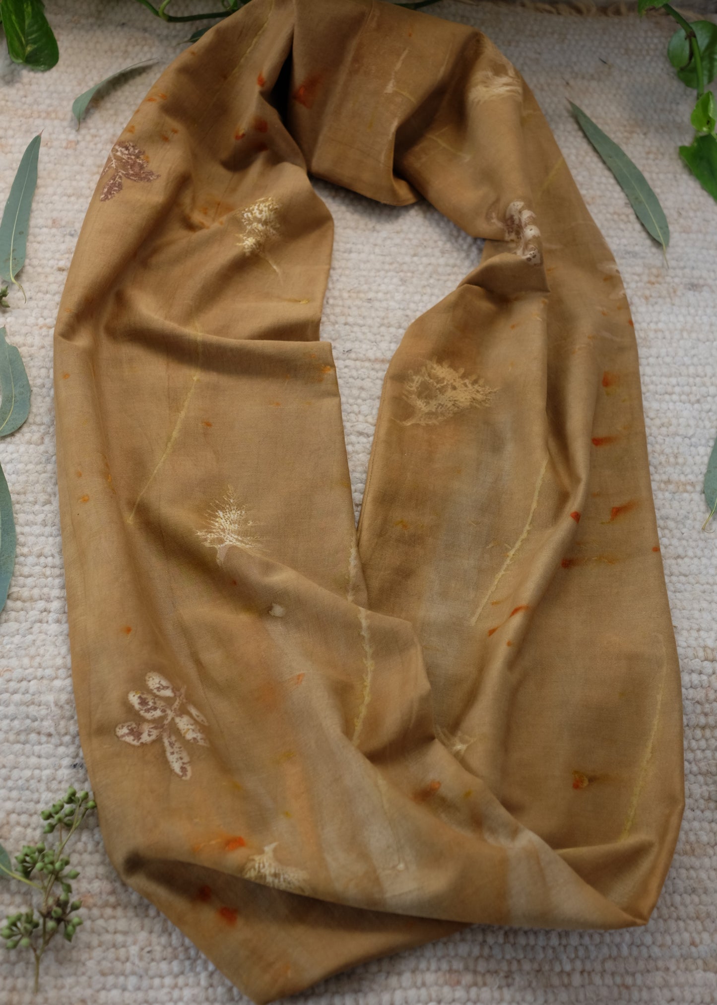 ecoprinted infinity scarf in brown color with beighe and orange  prints. 