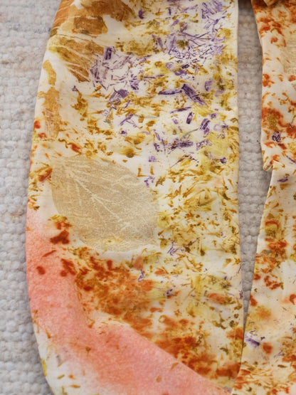 detail froma  bundle dyed scarf with logood, marigolds, madder and cosmos flowers.