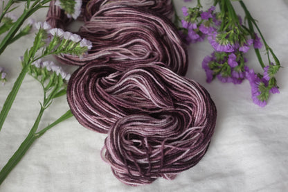 Botanically dyed vegan sock yarn in soft, vibrant colors, made from plant-based fibers for a sustainable, eco-friendly option