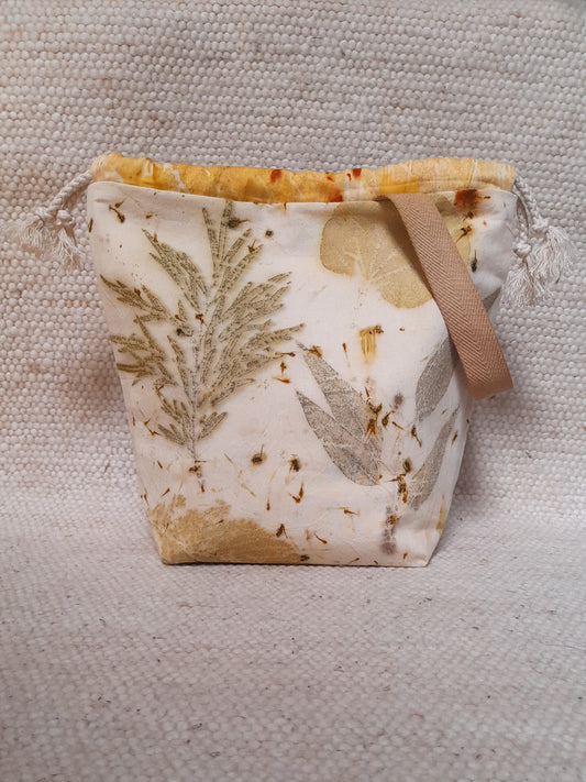 handmade project bag, with ecoprinted fabric. various leaves in white background
