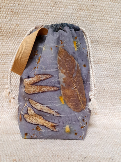 project bag made with ecoprinted fabric. various leaves in a blu background.