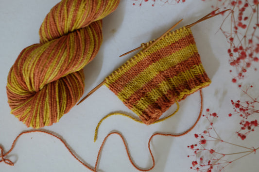 Botanically dyed vegan sock yarn in soft, vibrant colors, made from plant-based fibers for a sustainable, eco-friendly option